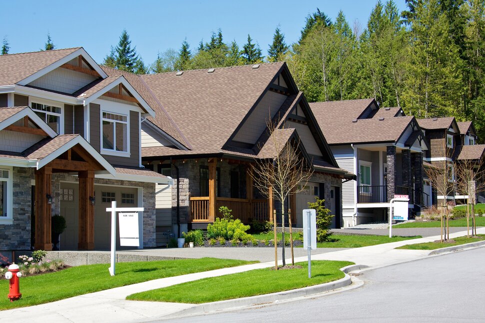 Suburban home with well-maintained lawn representing property preservation services